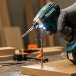 Makita XDT19Z impact driver in use on a woodworking project, showing ergonomic grip and LED light.