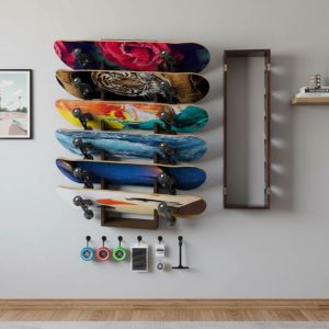 Organized bedroom wall displaying skateboards vertically on Koutemie rack with accessories hanging below