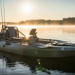 wide high weight capacity fishing kayak on calm lake