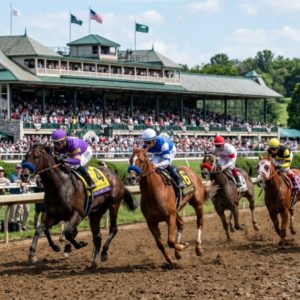 Thoroughbred horses racing on dirt track at Keeneland in Lexington Kentucky