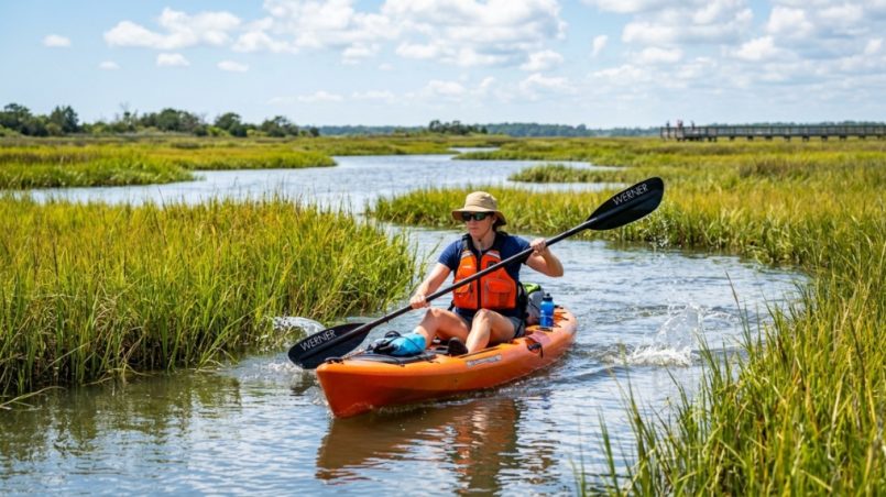 A family wearing approved life jackets on a boat in North Carolina.