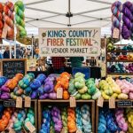 Colorful hand-dyed yarn skeins displayed at the Kings County Fiber Festival vendor market